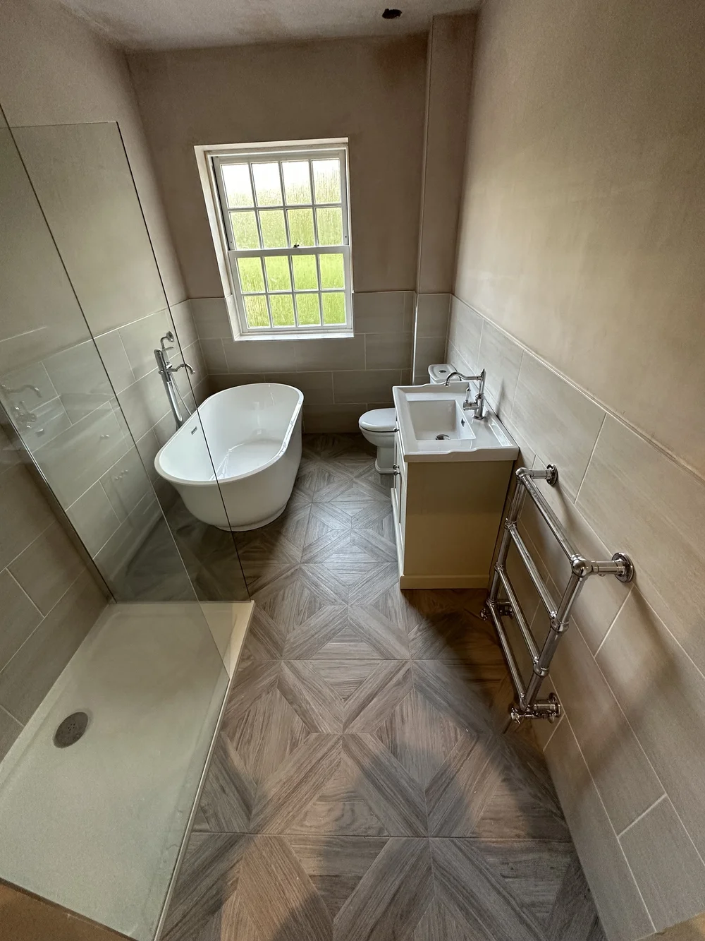 Traditional bathroom with freestanding slipper bath, cream shaker vanity and parquet floor — bathroom renovation